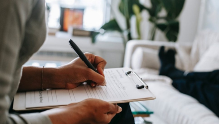 lady writing on clipboard