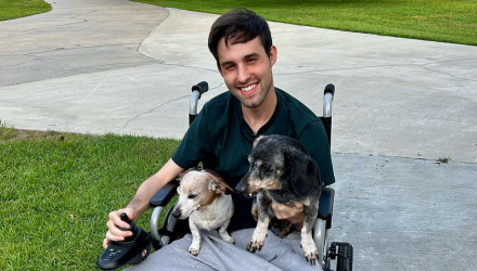 Photo of Kyle Duhon and two puppies